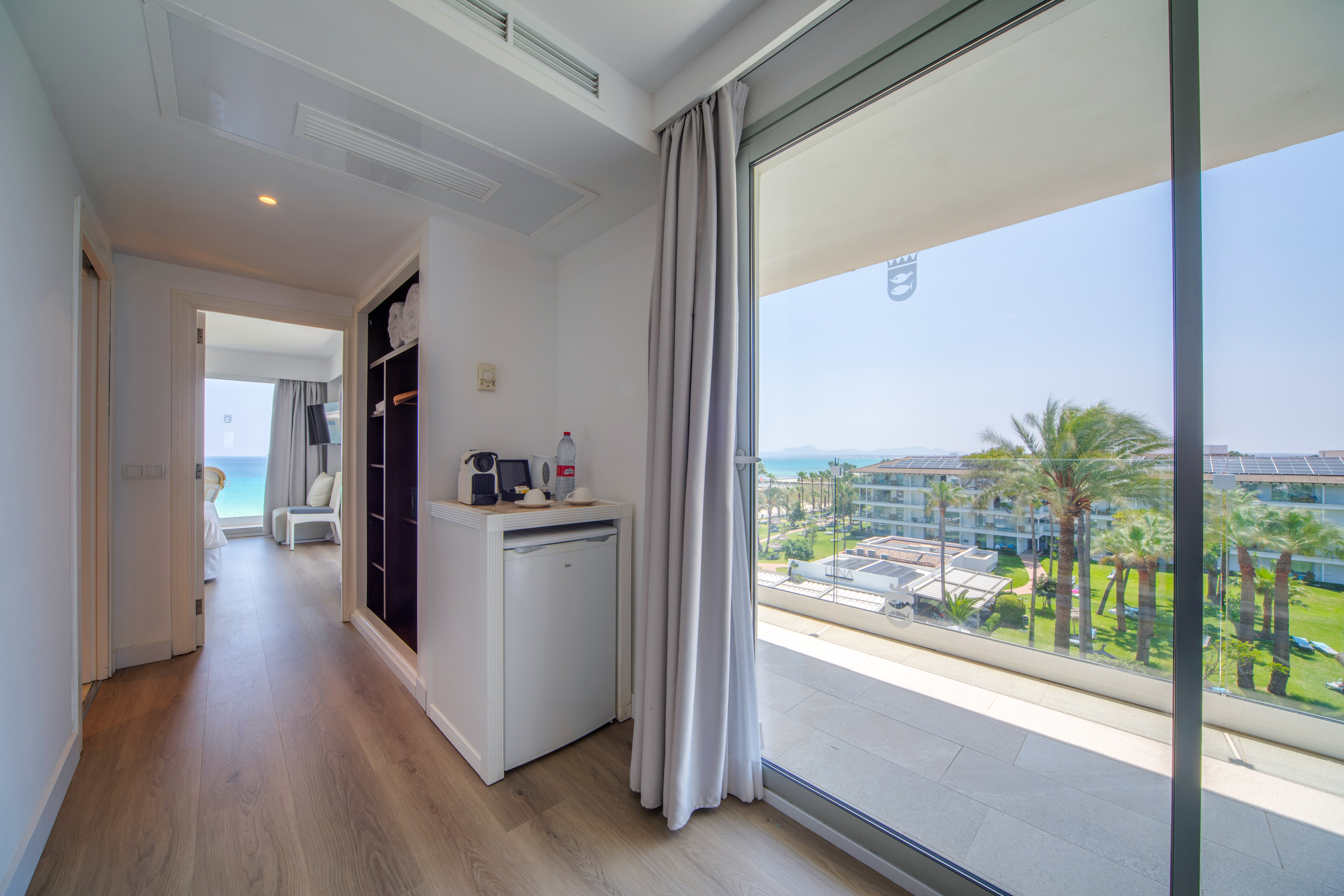 a room with a view of the ocean and a beach