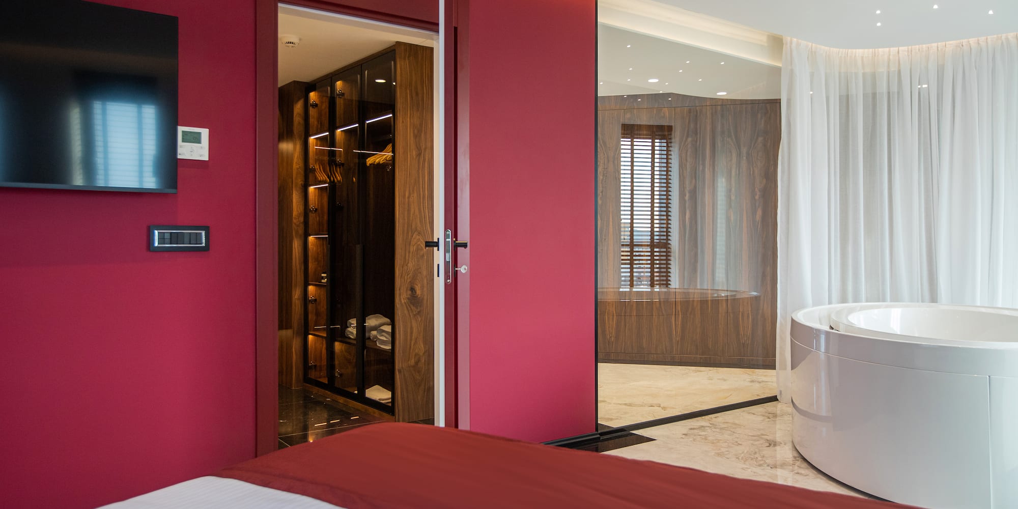 a room with a tub and a bed