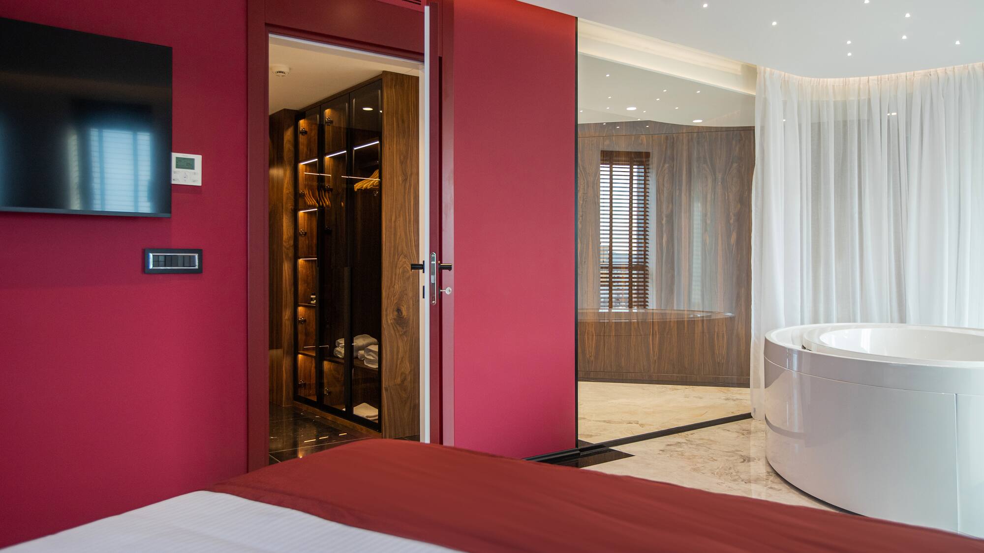 a room with a tub and a bed