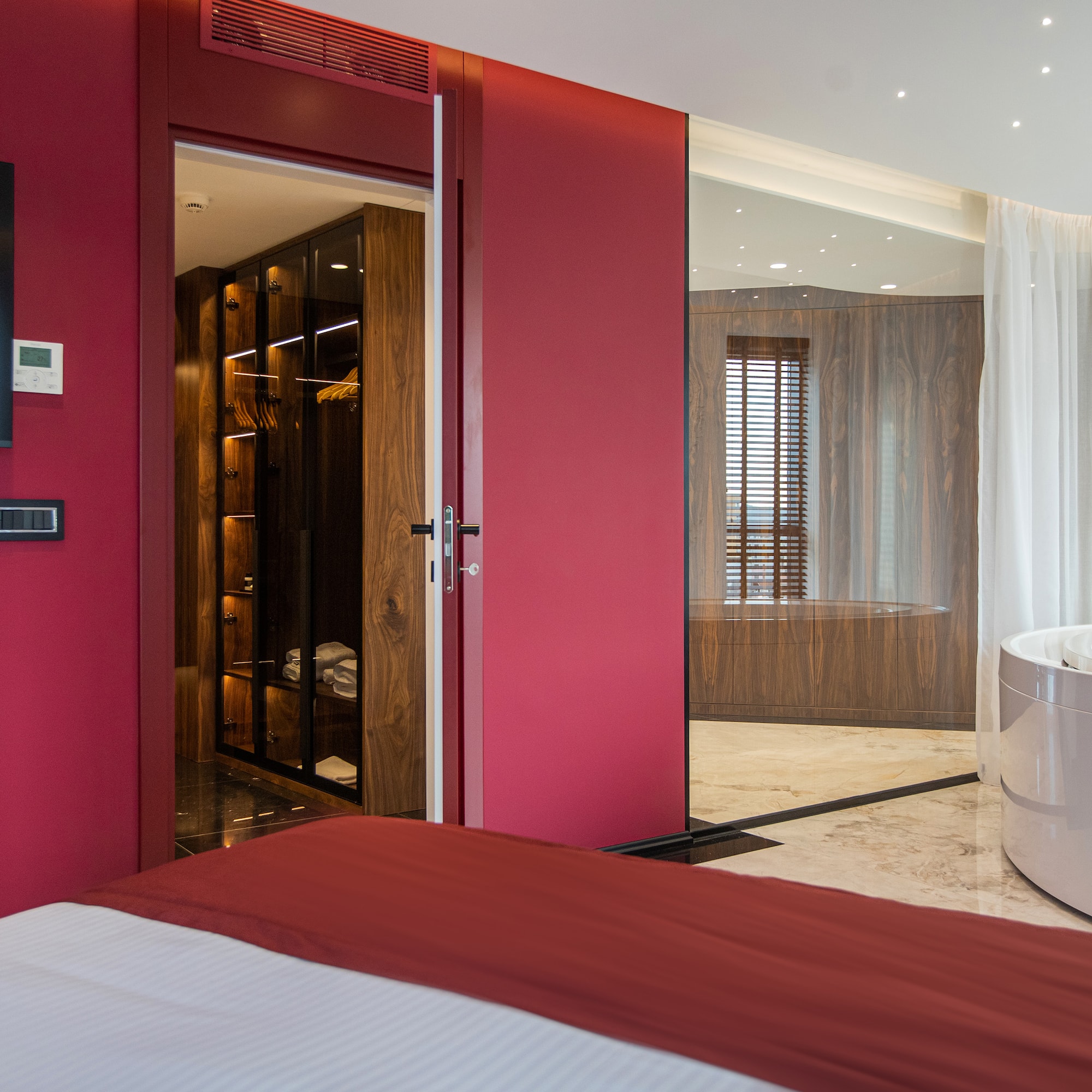 a room with a tub and a bed