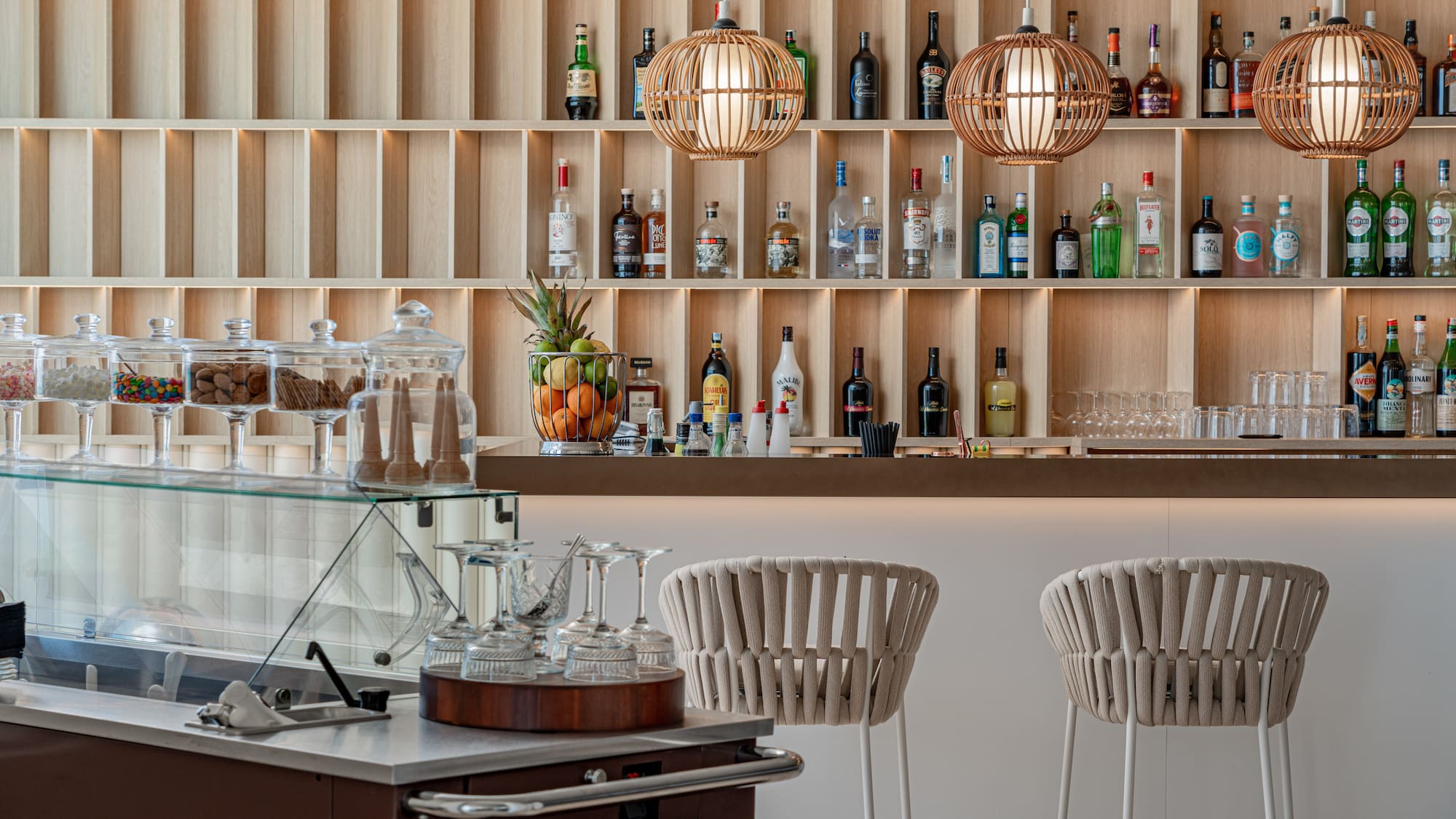 a bar with shelves of liquor bottles and glasses