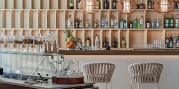 a bar with shelves of liquor bottles and glasses