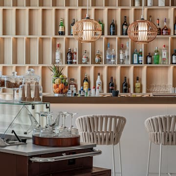 a bar with shelves of liquor bottles and glasses