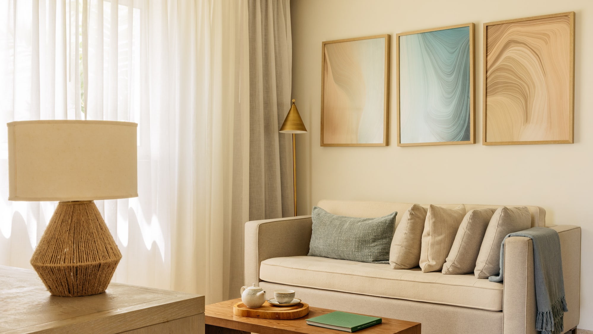 Modern living room with beige sofa, abstract wall art, and neutral decor.