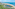 a beach with buildings and a body of water