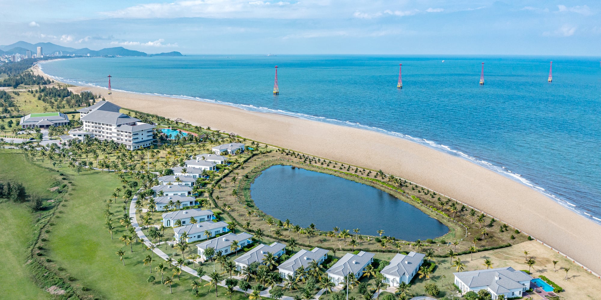 a beach with buildings and a body of water
