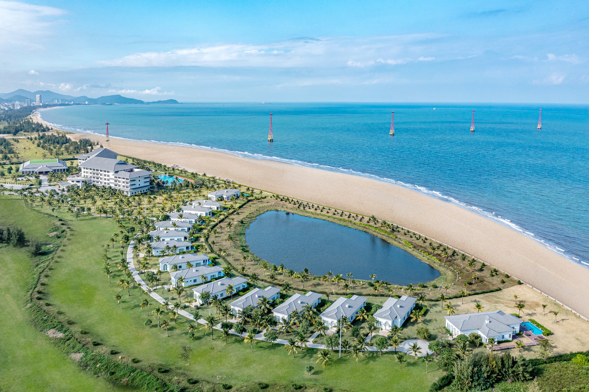 a beach with buildings and a body of water