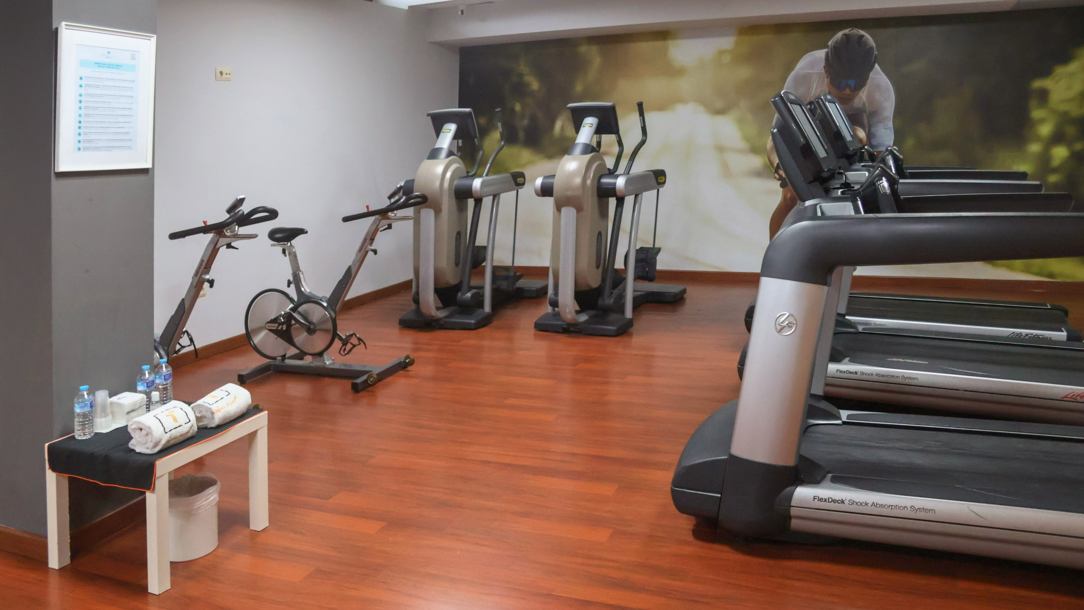 Fitness center with treadmills, elliptical machines, and spin bikes.