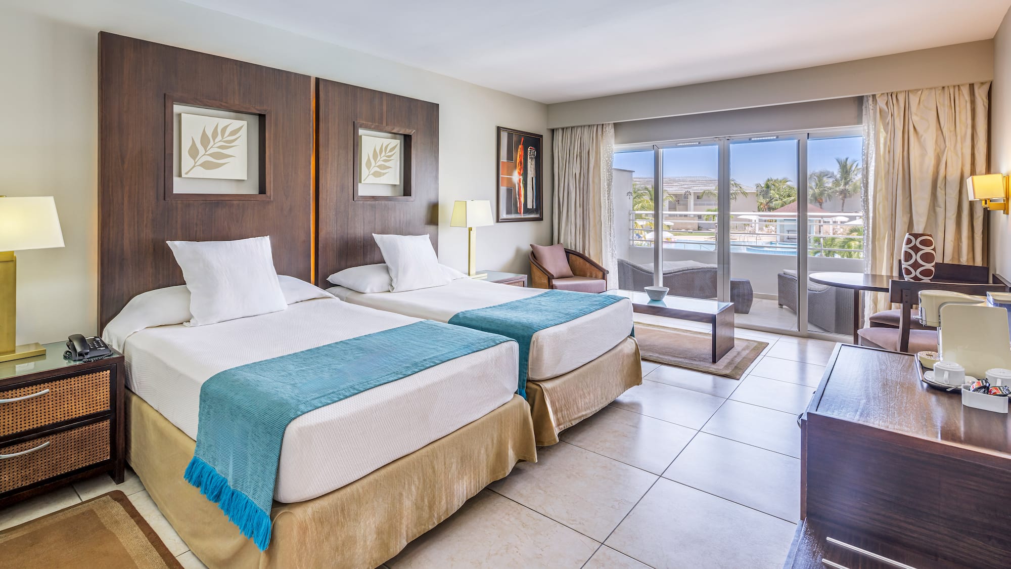 a room with two beds and a pool in the background