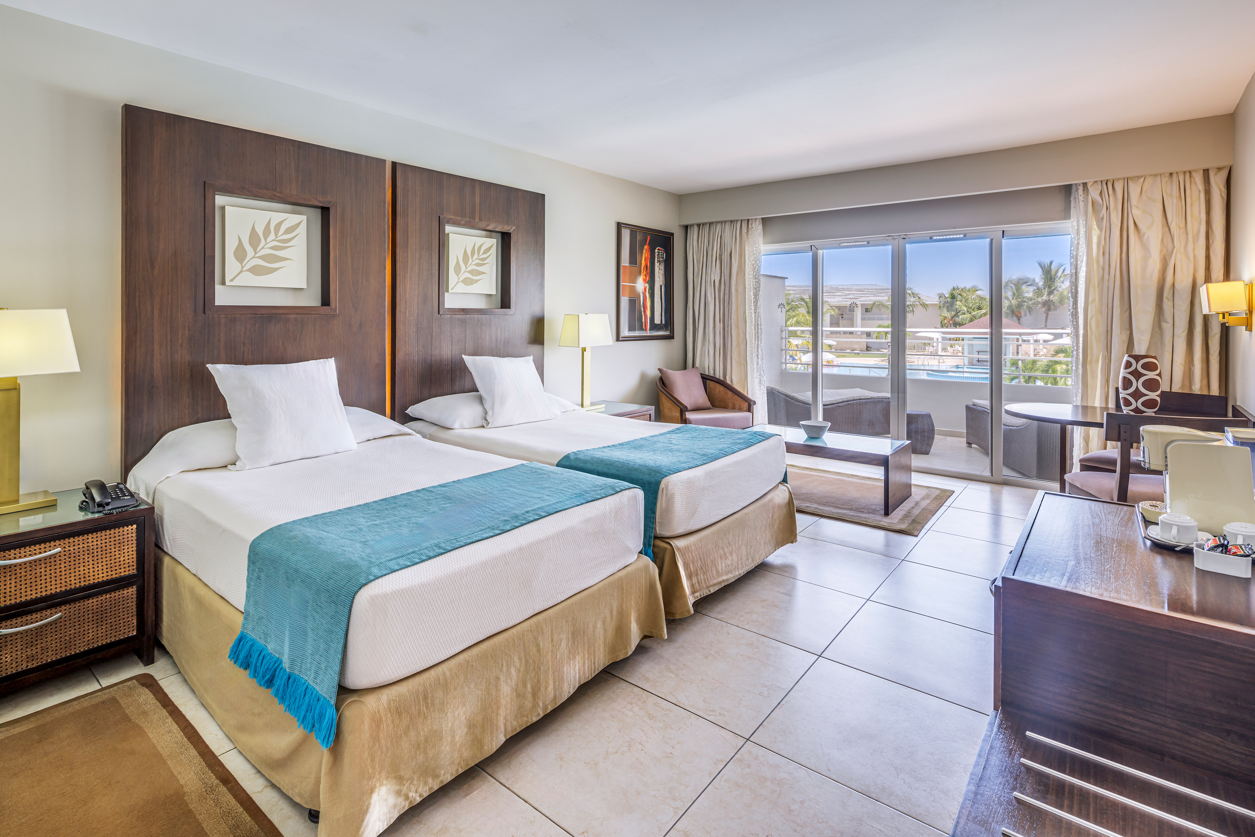 a room with two beds and a pool in the background