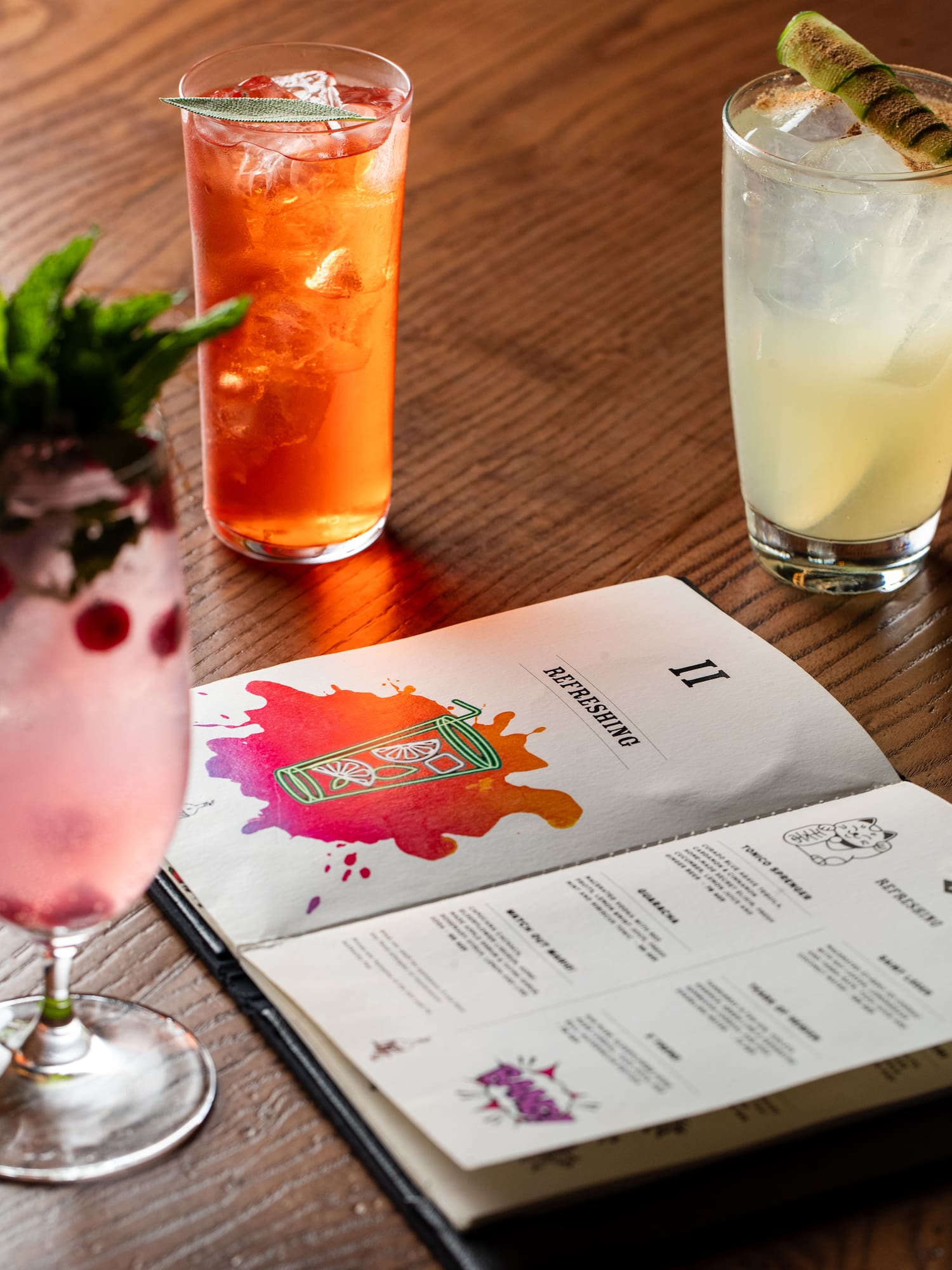 a menu and drinks on a table
