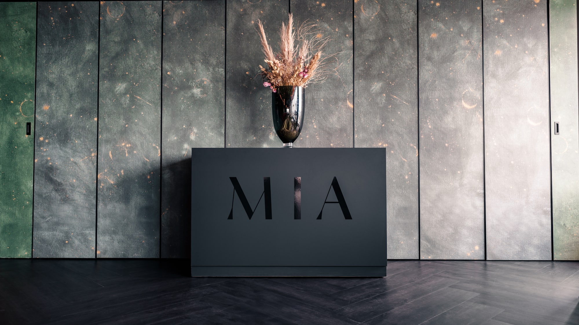 a vase of flowers on a black box