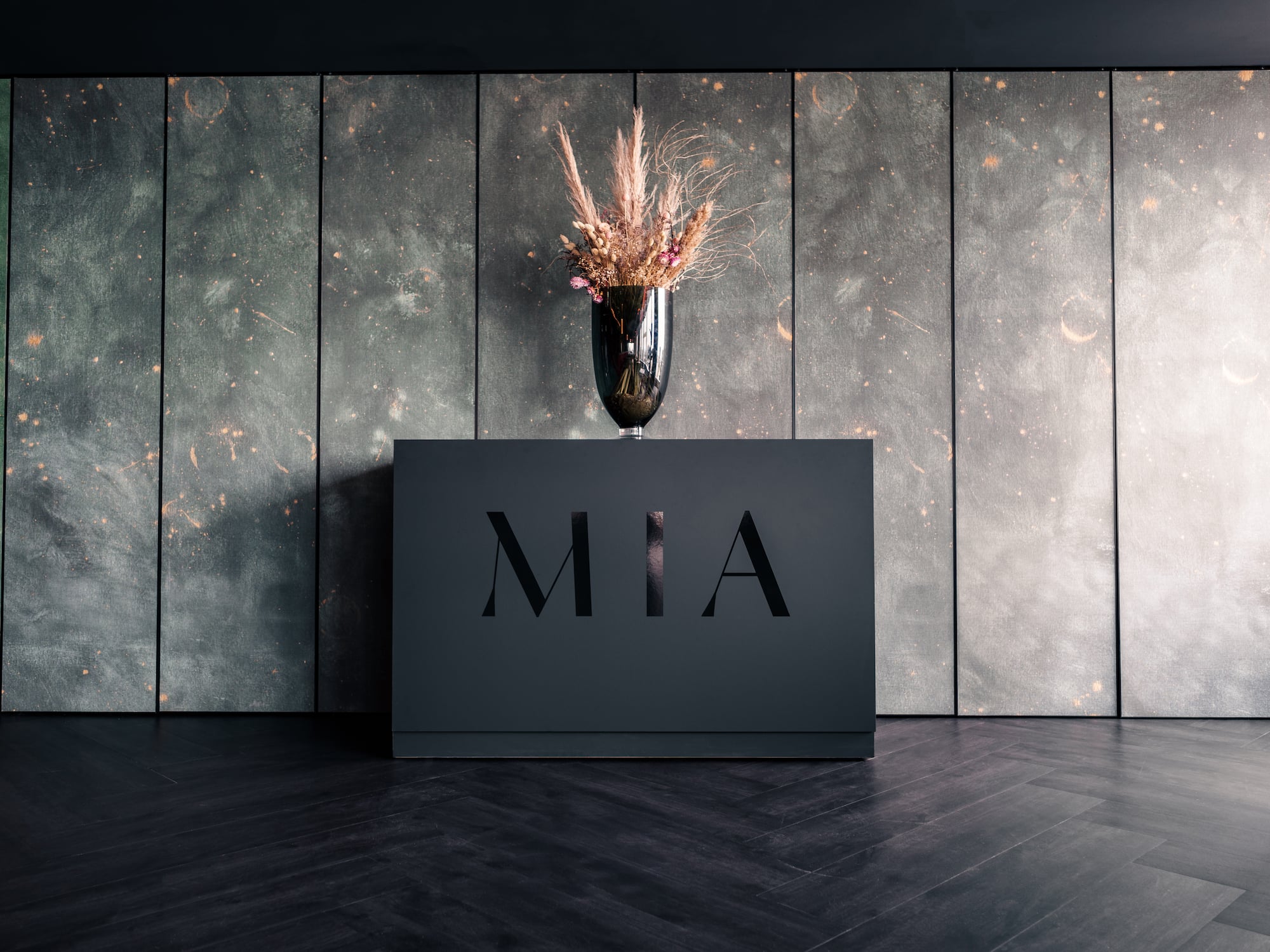 a vase of flowers on a black box