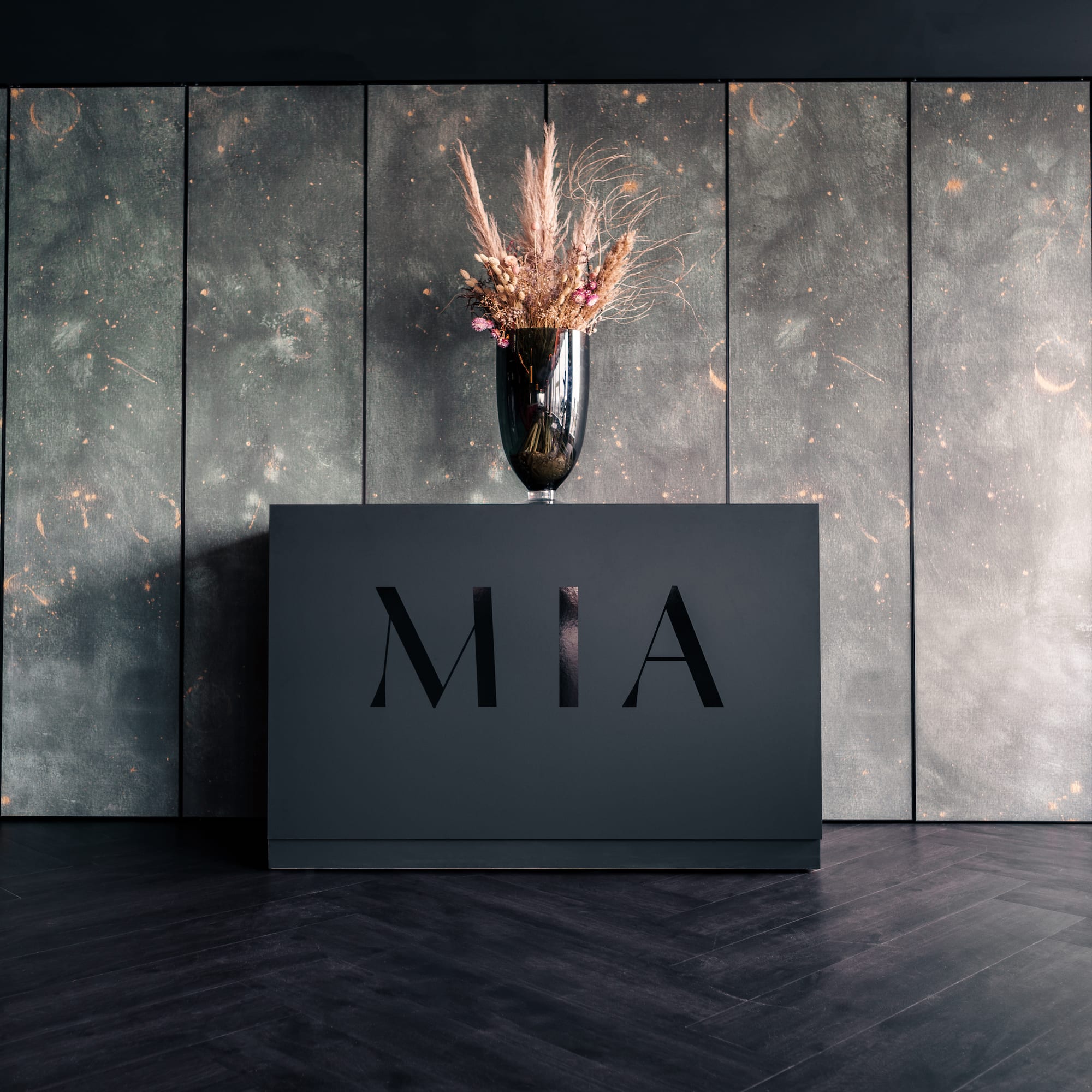 a vase of flowers on a black box