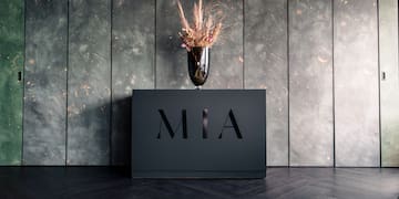 a vase of flowers on a black box