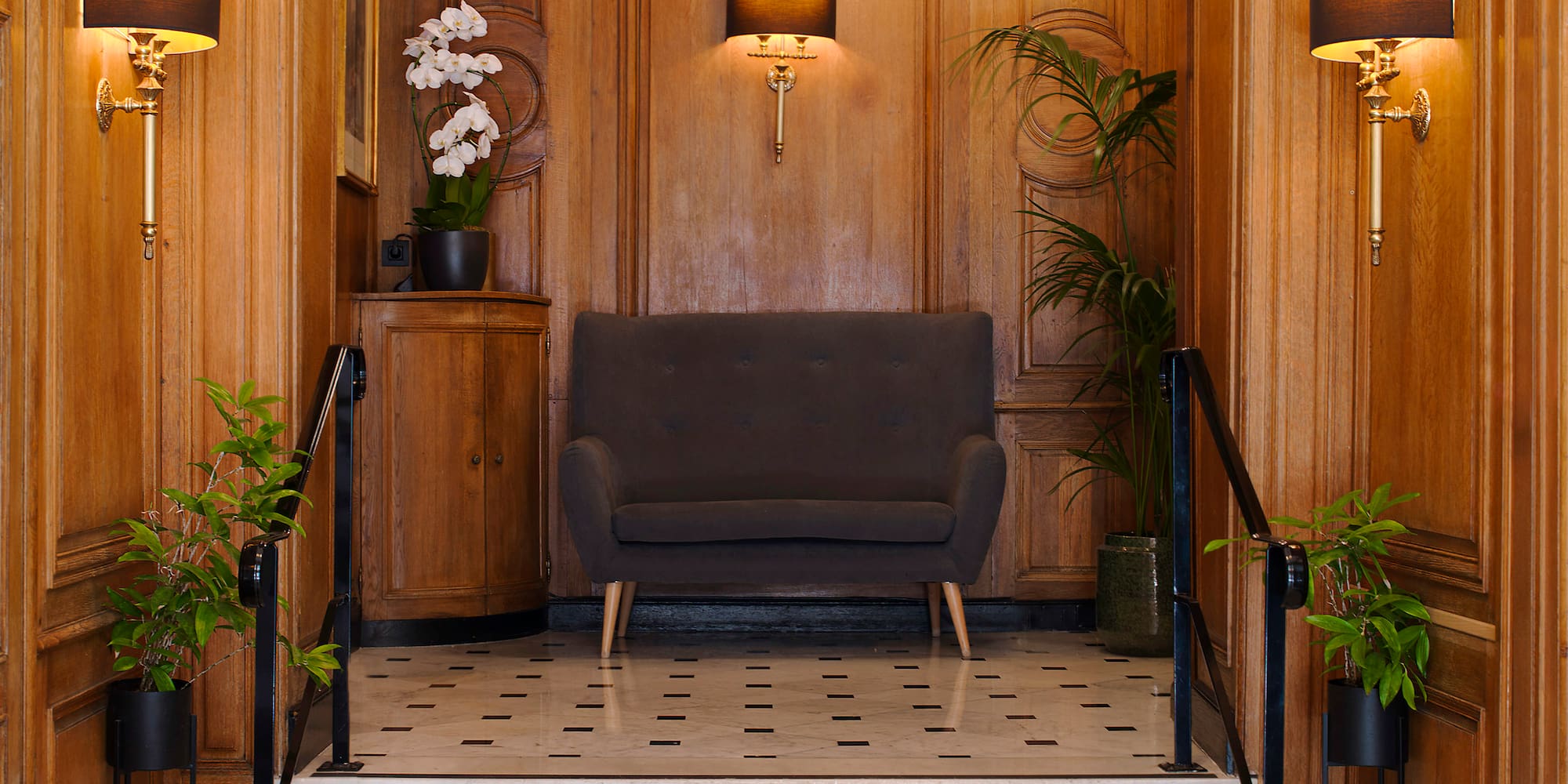 a hallway with a couch and stairs