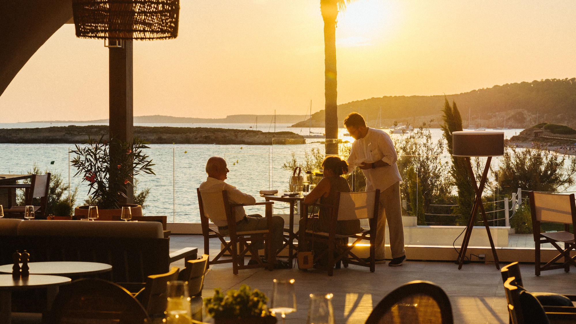 a group of people sitting at tables outside