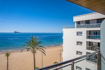 a beach with palm trees and a building
