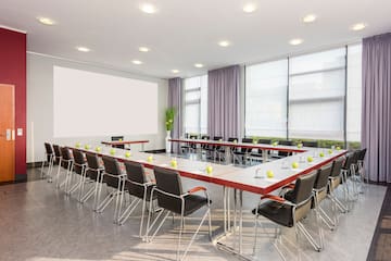 a room with a large table and chairs