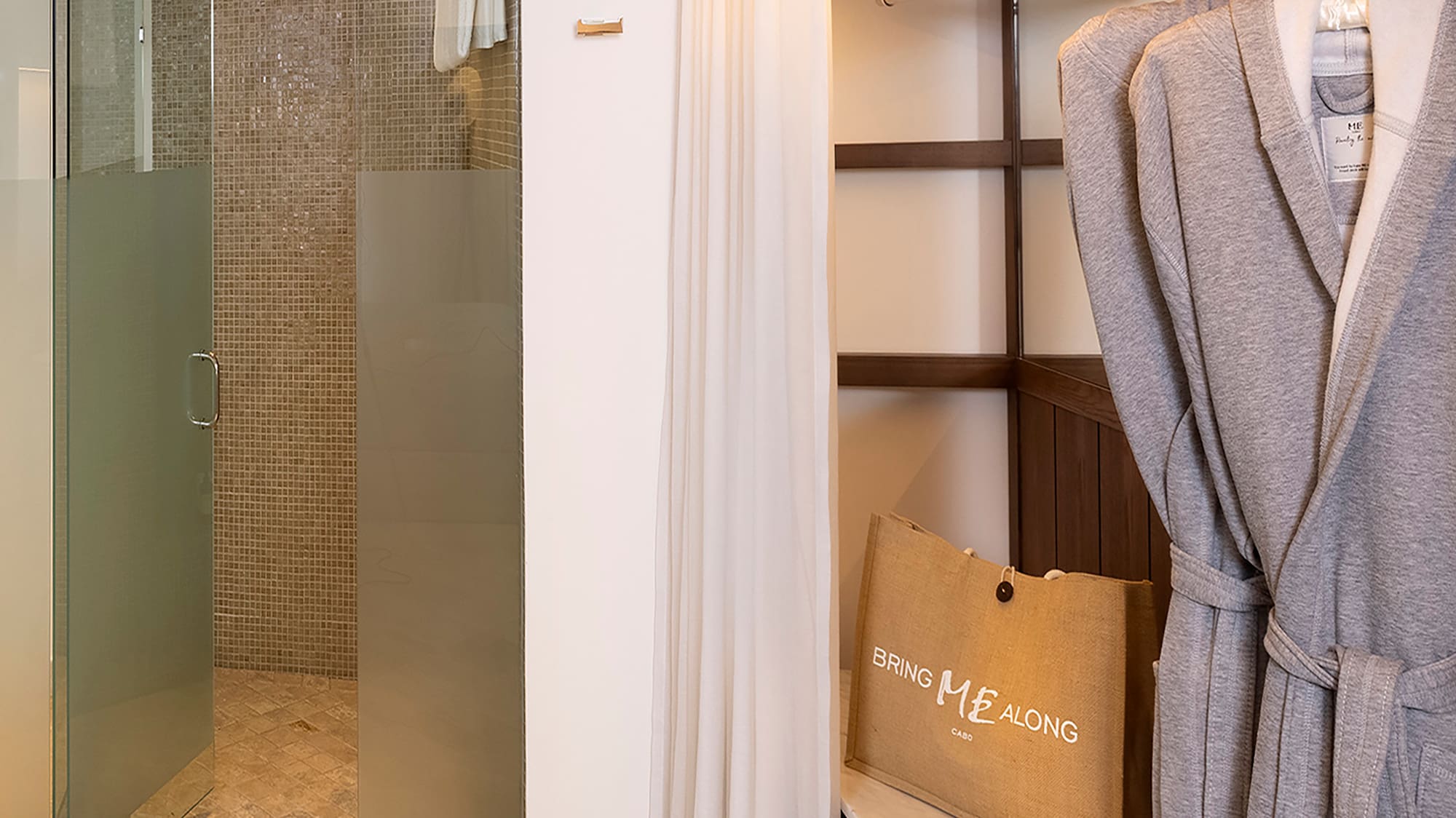 a bathroom with a shower and bathrobe