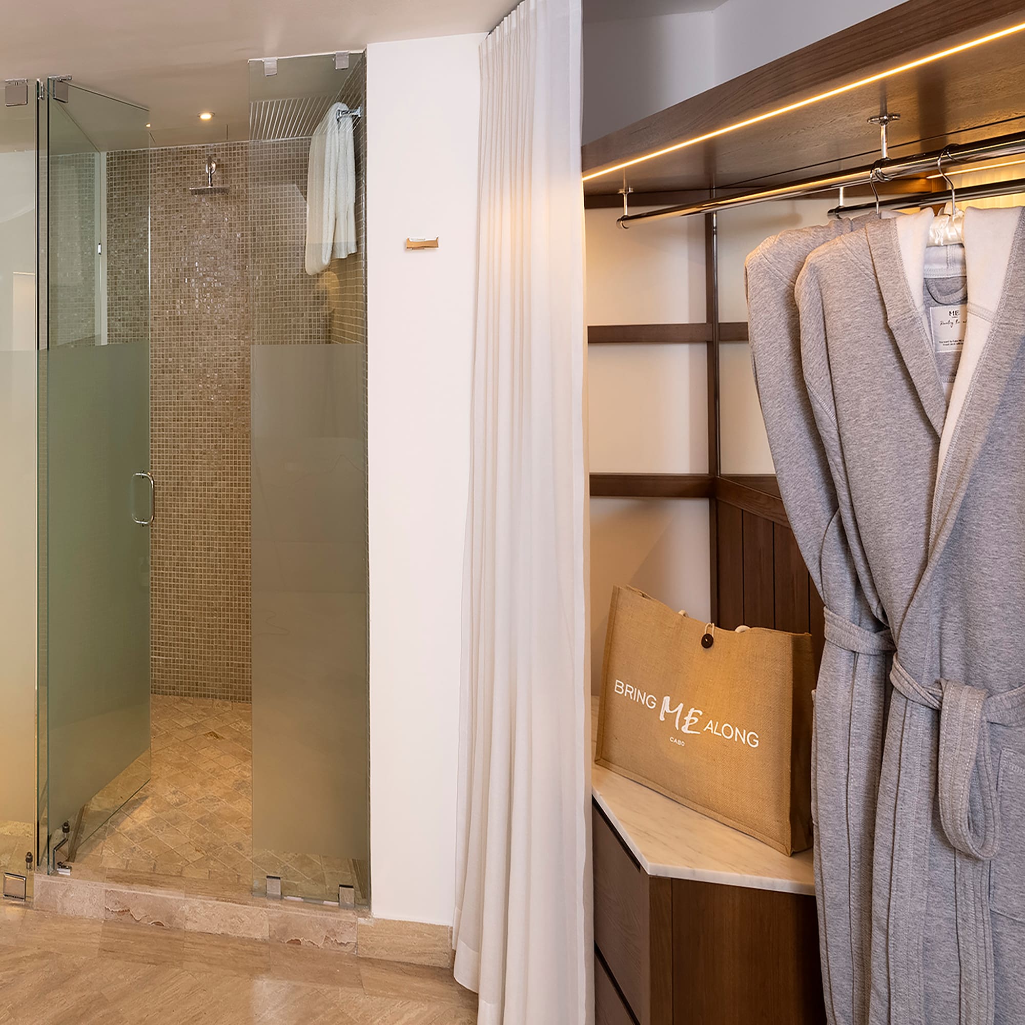 a bathroom with a shower and bathrobe