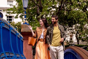 a man and woman walking on a bridge