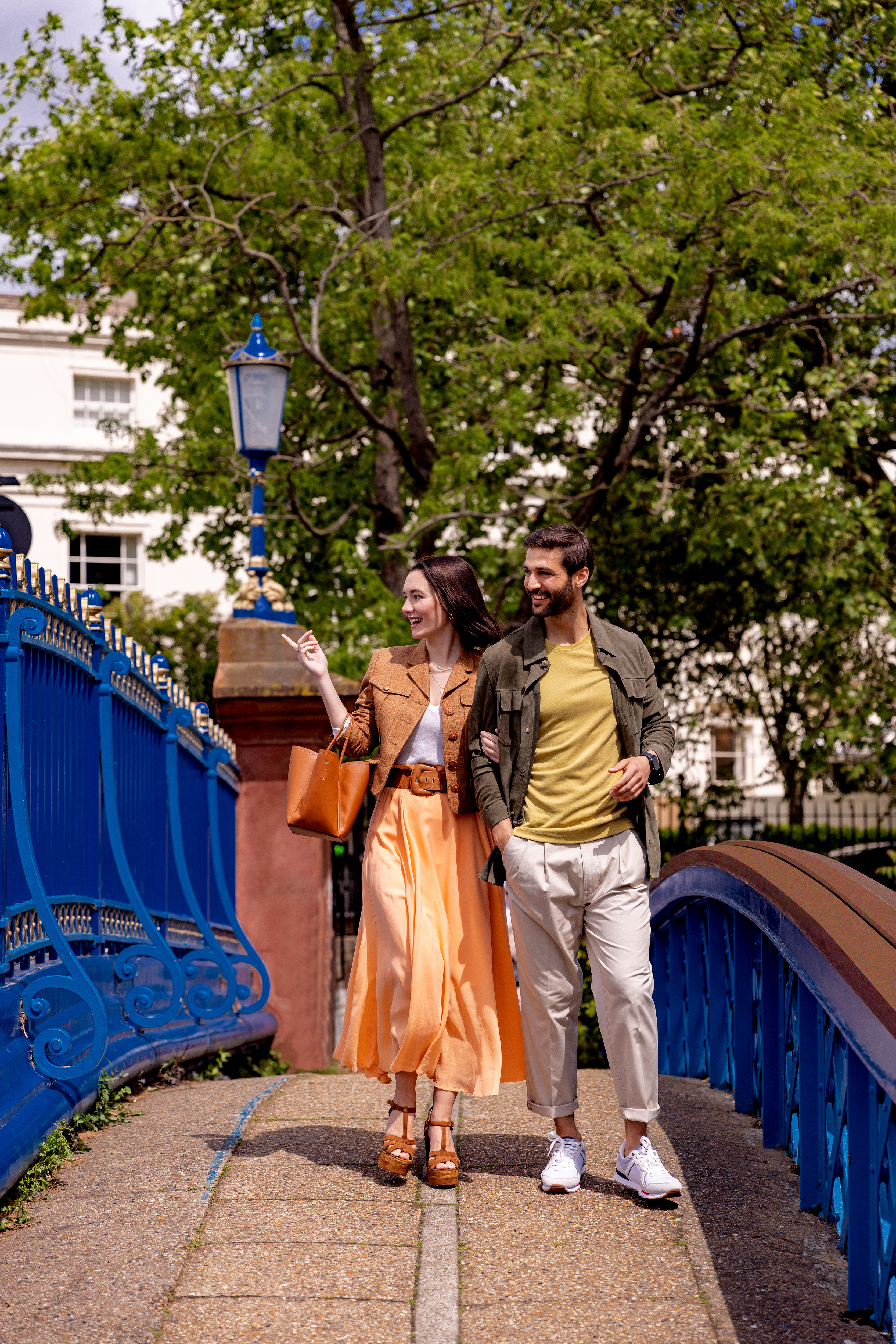 a man and woman walking on a bridge