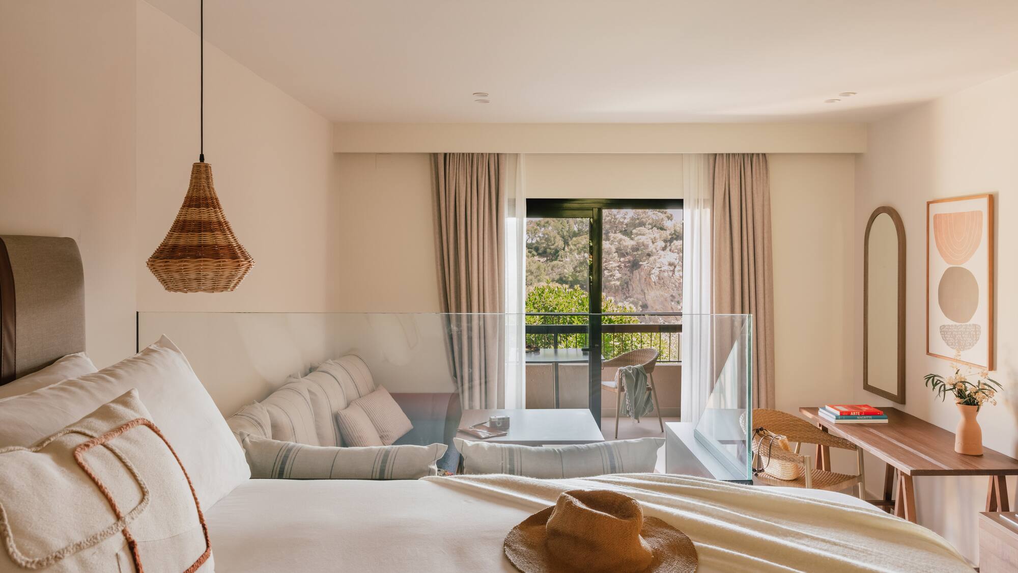 a room with a bed and a table and chairs