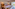 Modern hotel bedroom with king bed, sofa, and patio garden view.