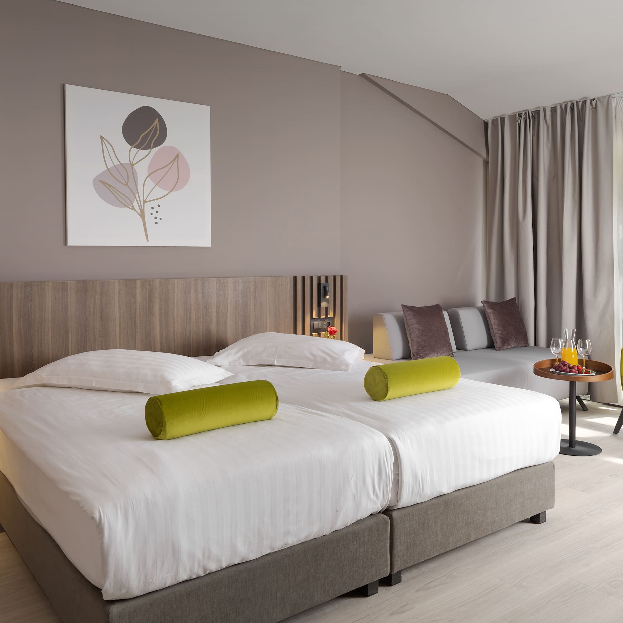 a room with two beds and a table