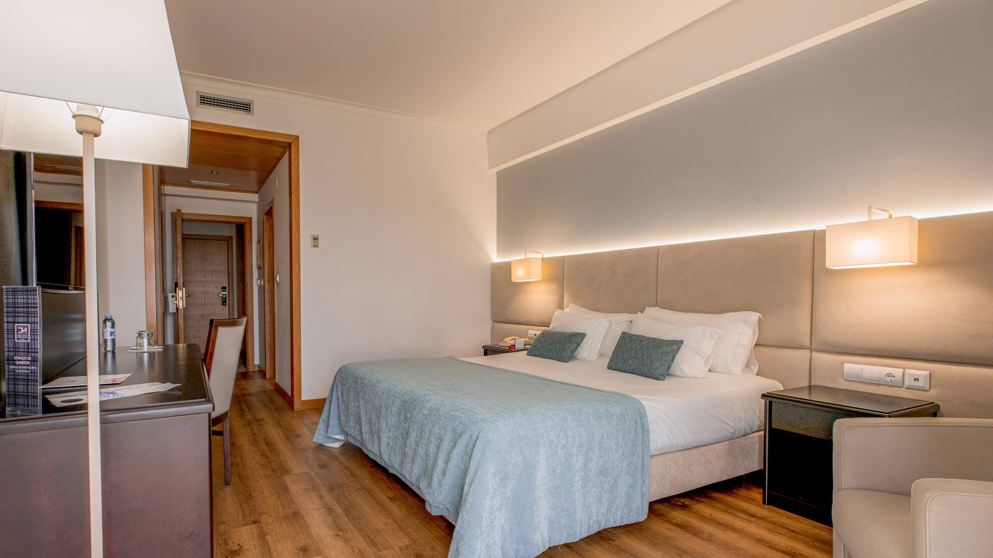 a bedroom with a bed and a table