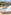 Luxury hotel rooftop with lounge chairs, plunge pool, and scenic mountain landscape.