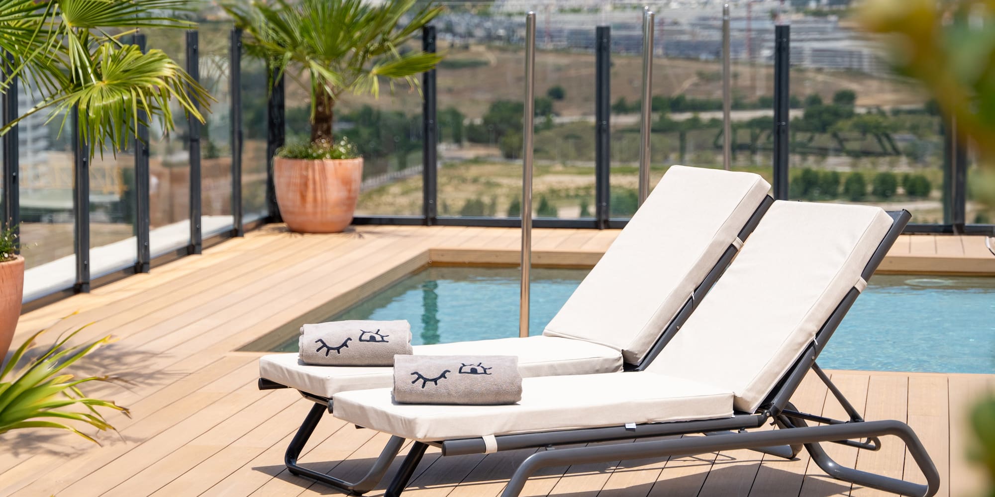 a deck with chairs and a pool