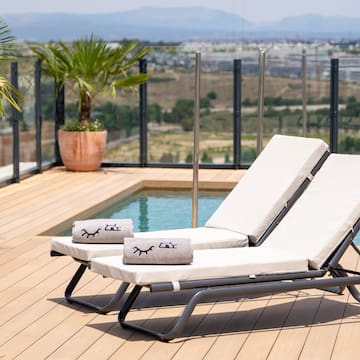 a deck with chairs and a pool