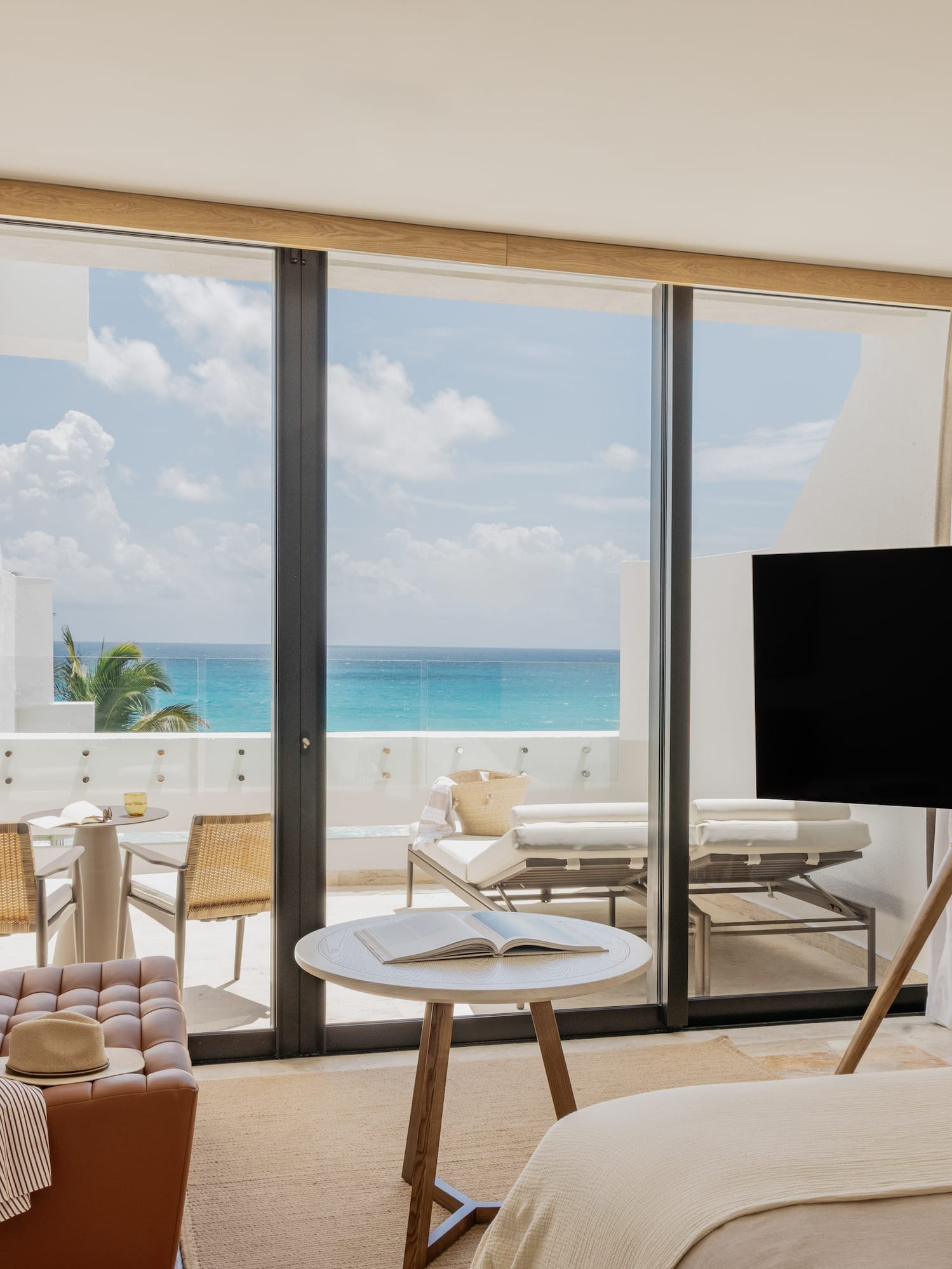 Luxury oceanfront hotel room with modern design and private balcony.