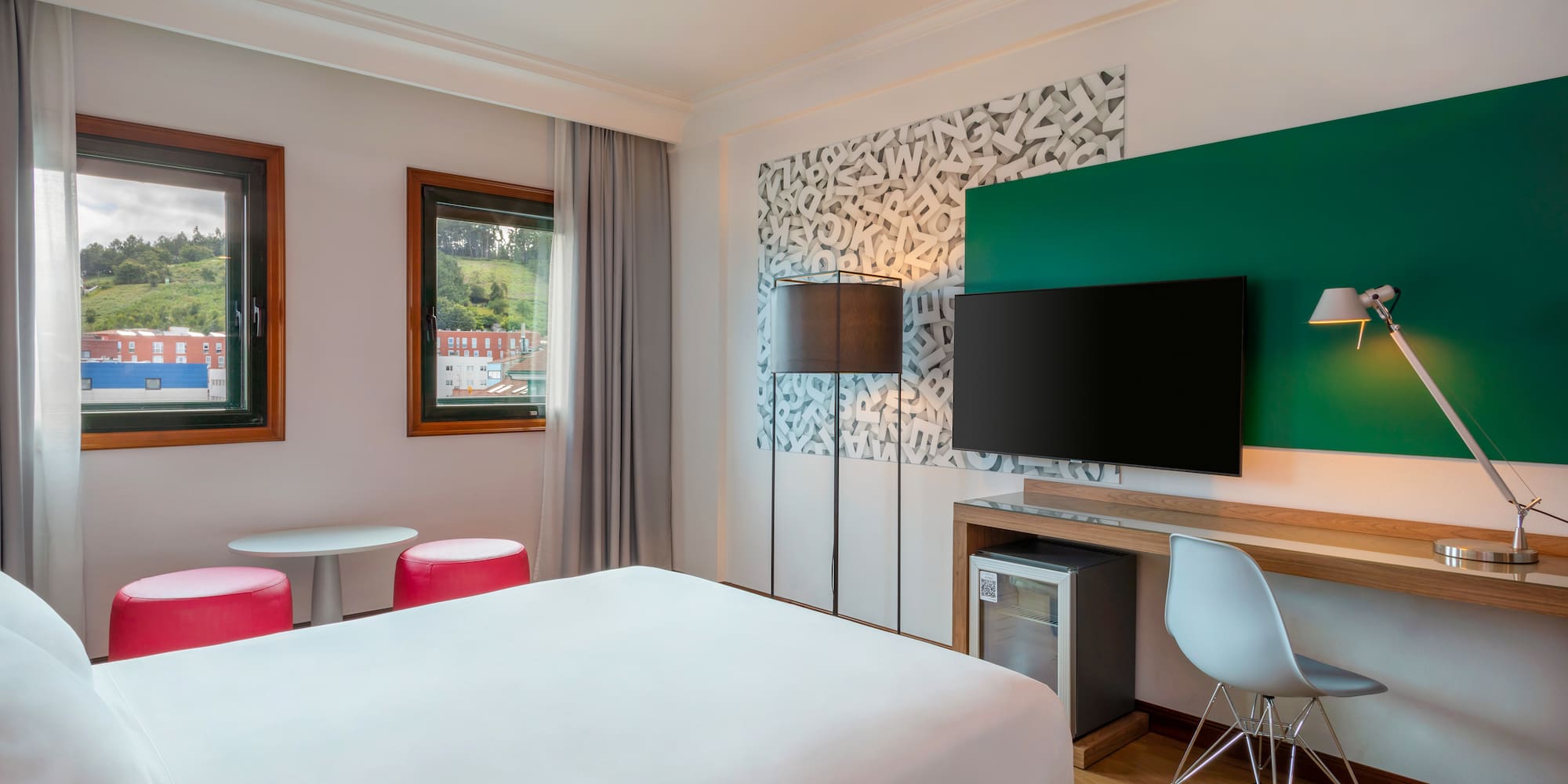 a room with a bed and a television