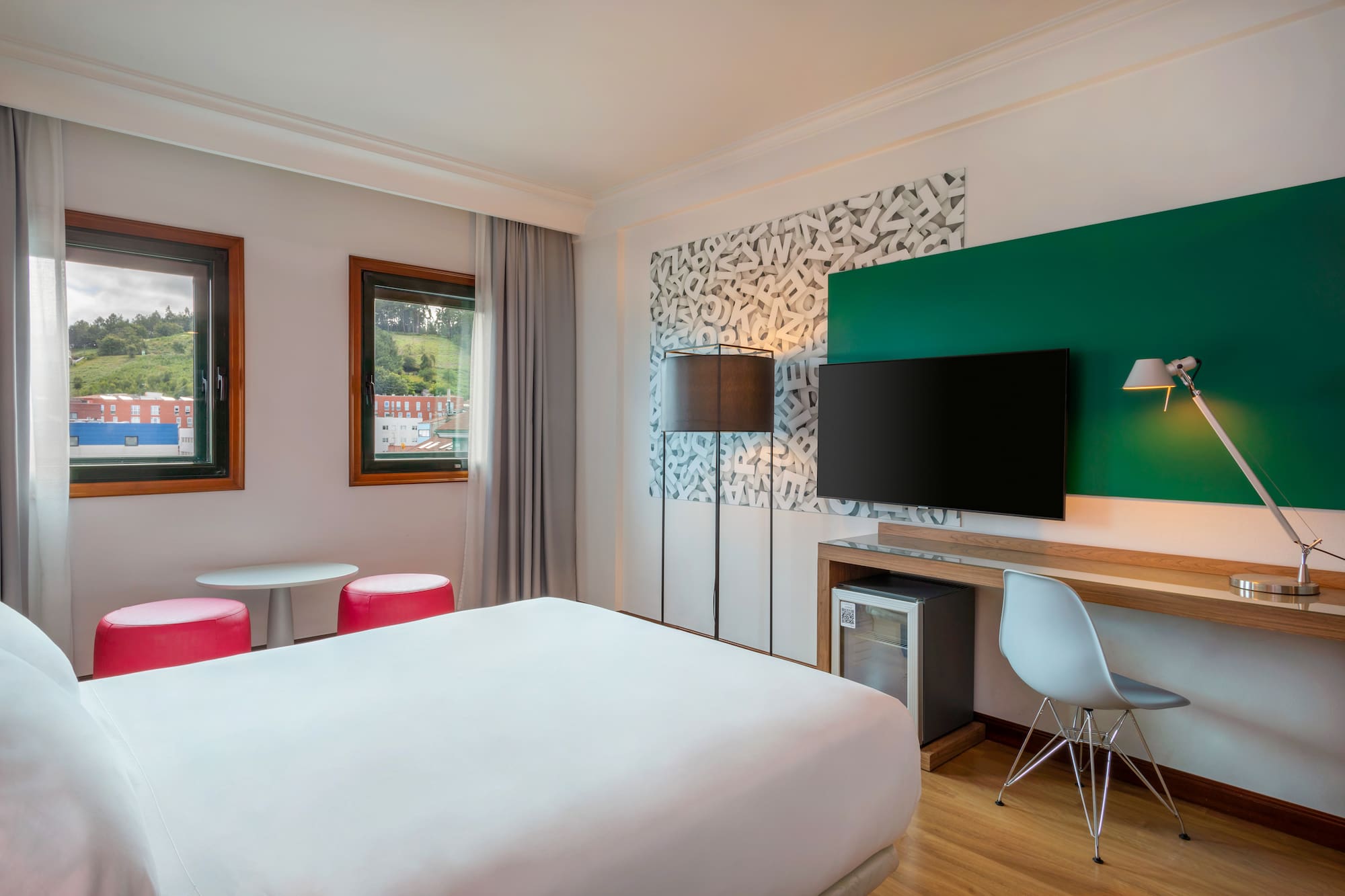 a room with a bed and a television