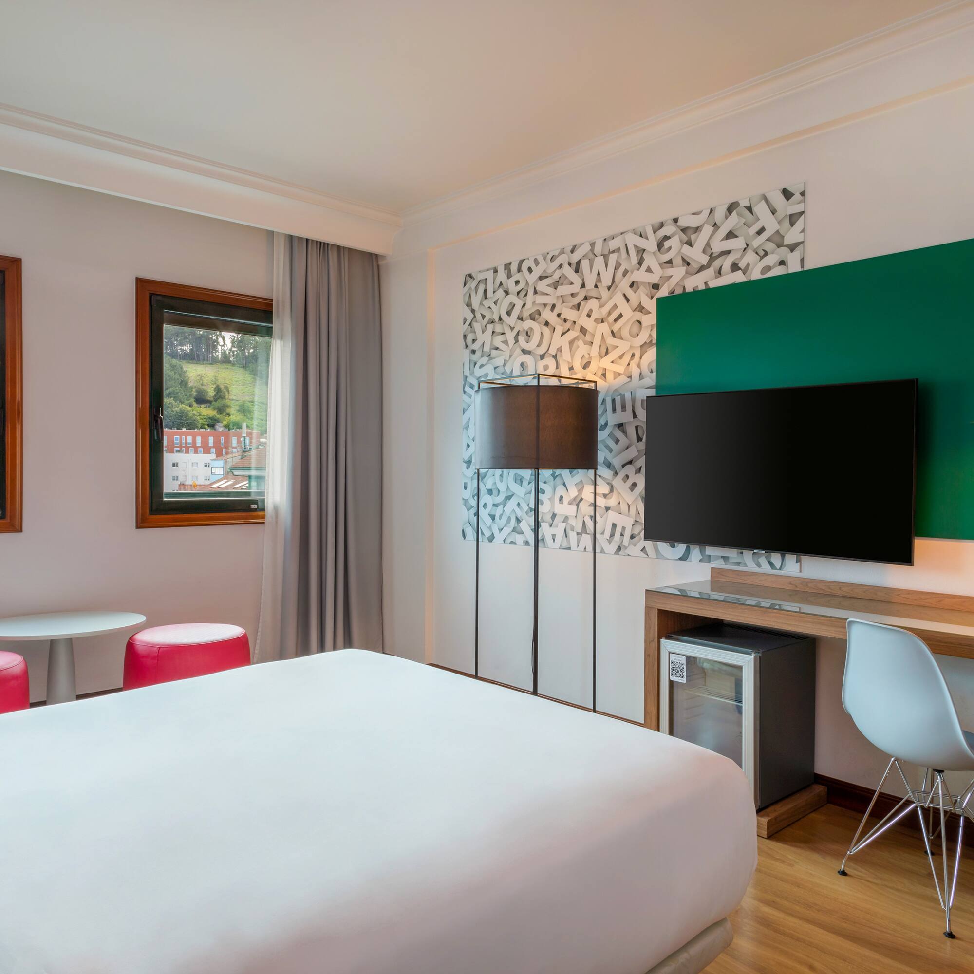 a room with a bed and a television