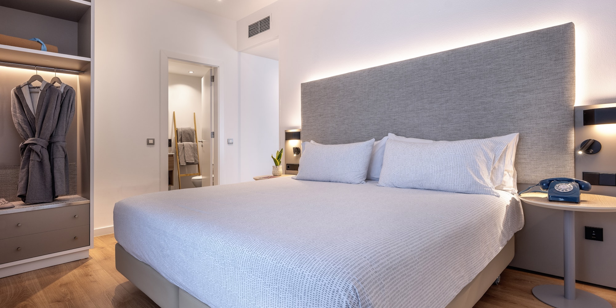 a bed with a headboard and a bookcase in a room