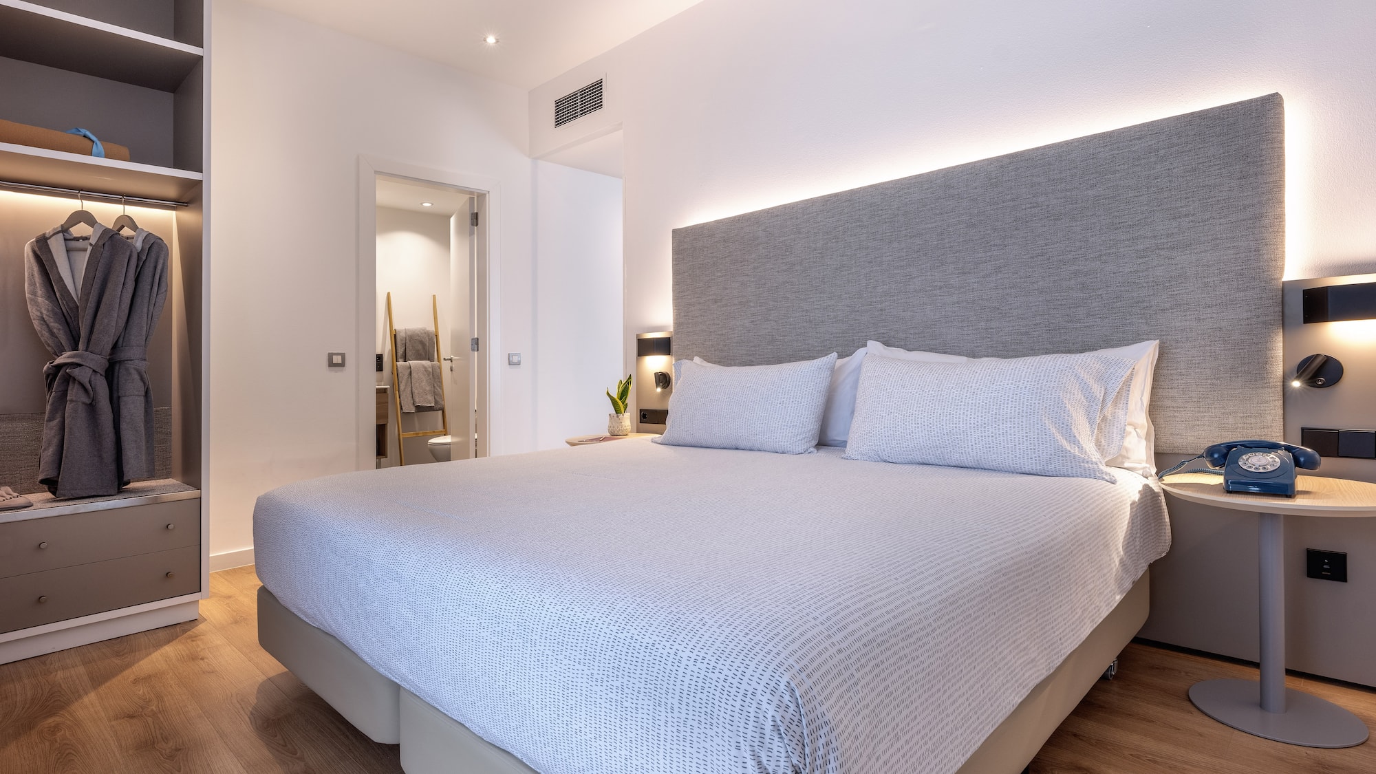 a bed with a headboard and a bookcase in a room