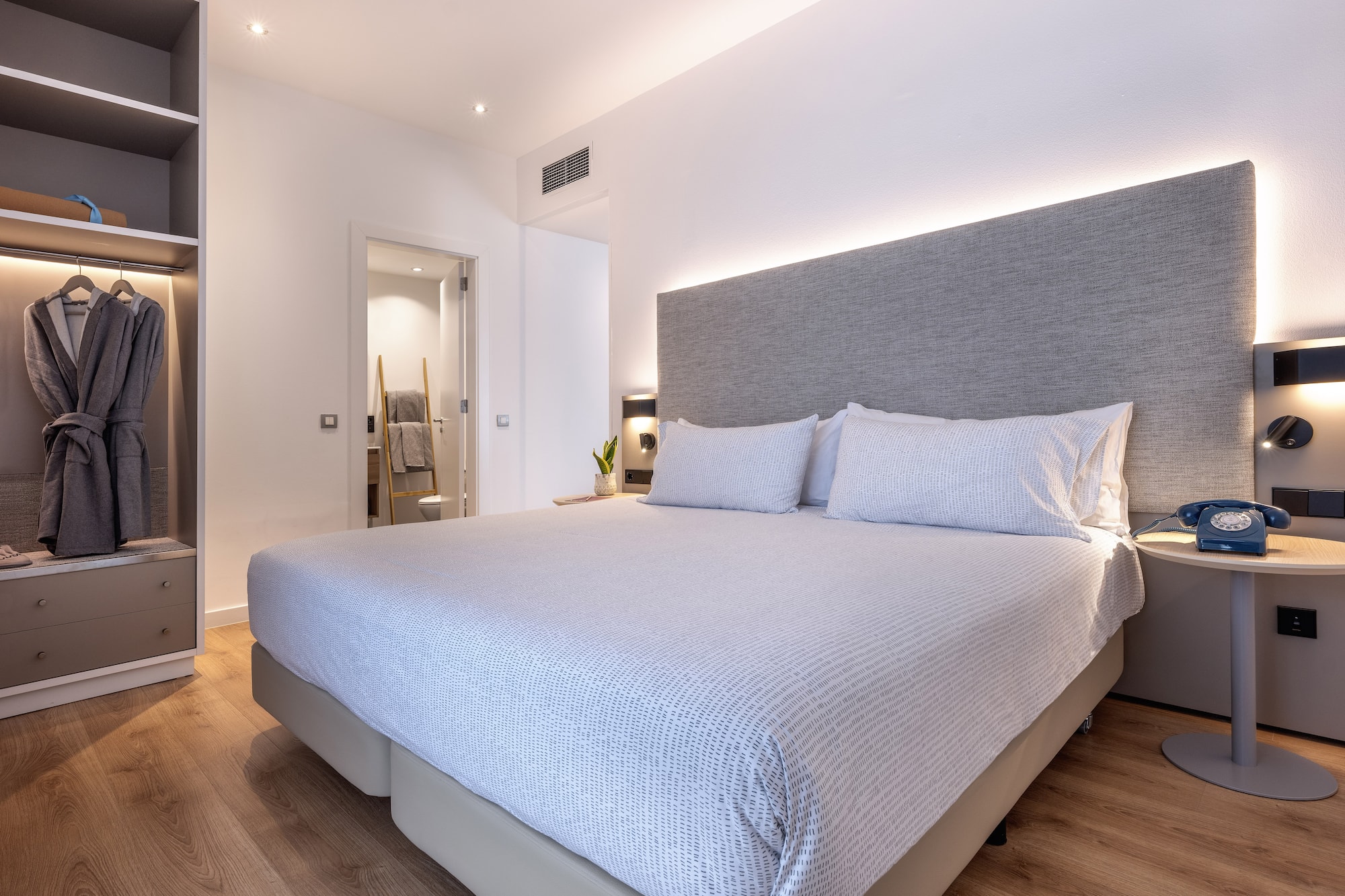 a bed with a headboard and a bookcase in a room
