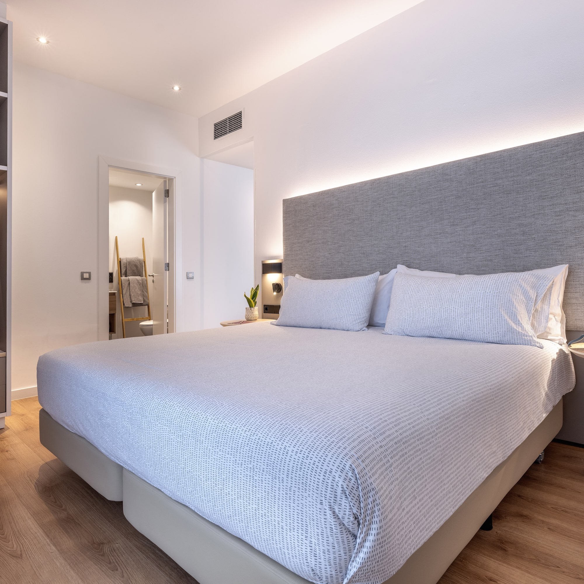 a bed with a headboard and a bookcase in a room