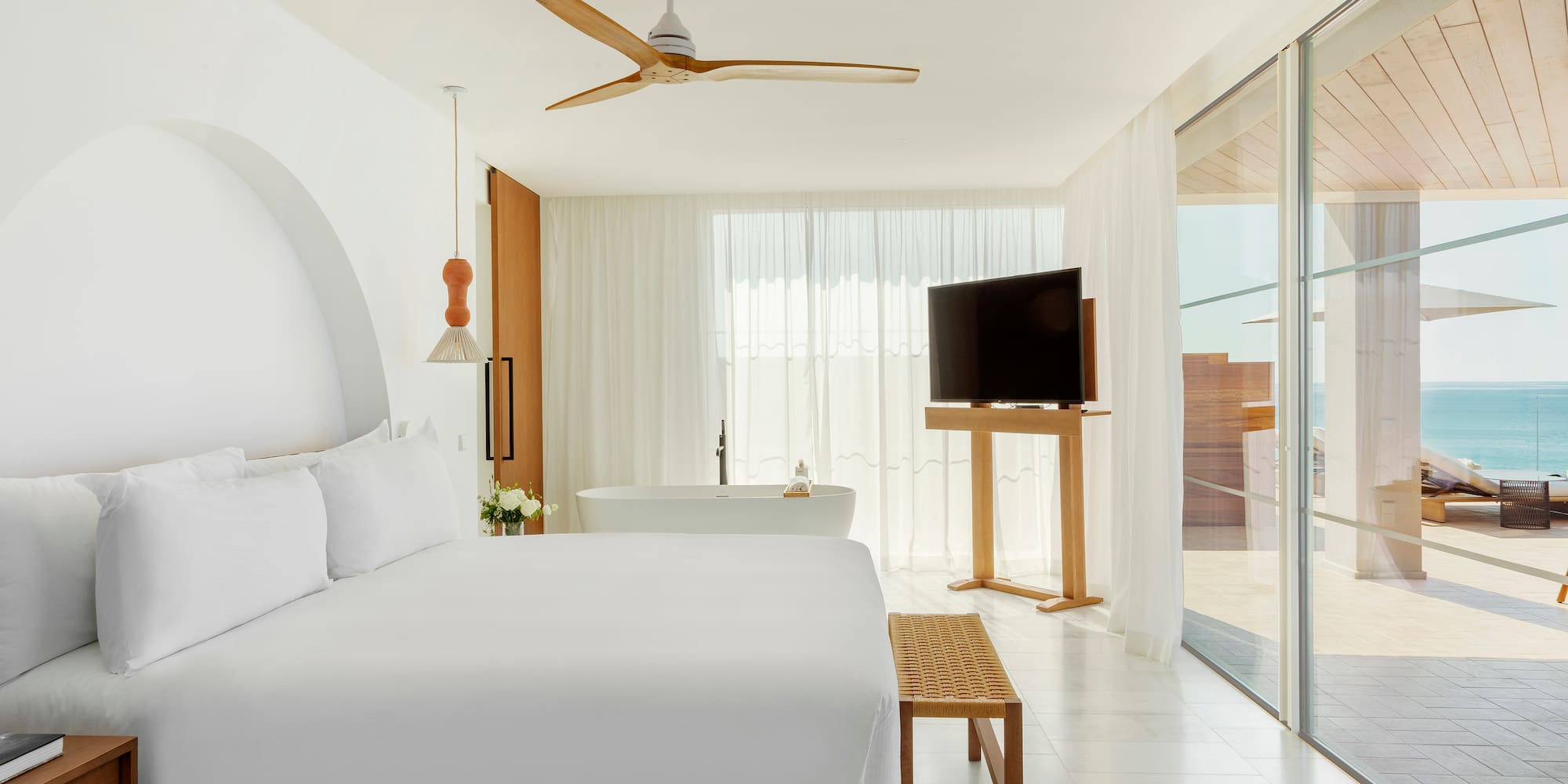 a bedroom with a large bed and a television