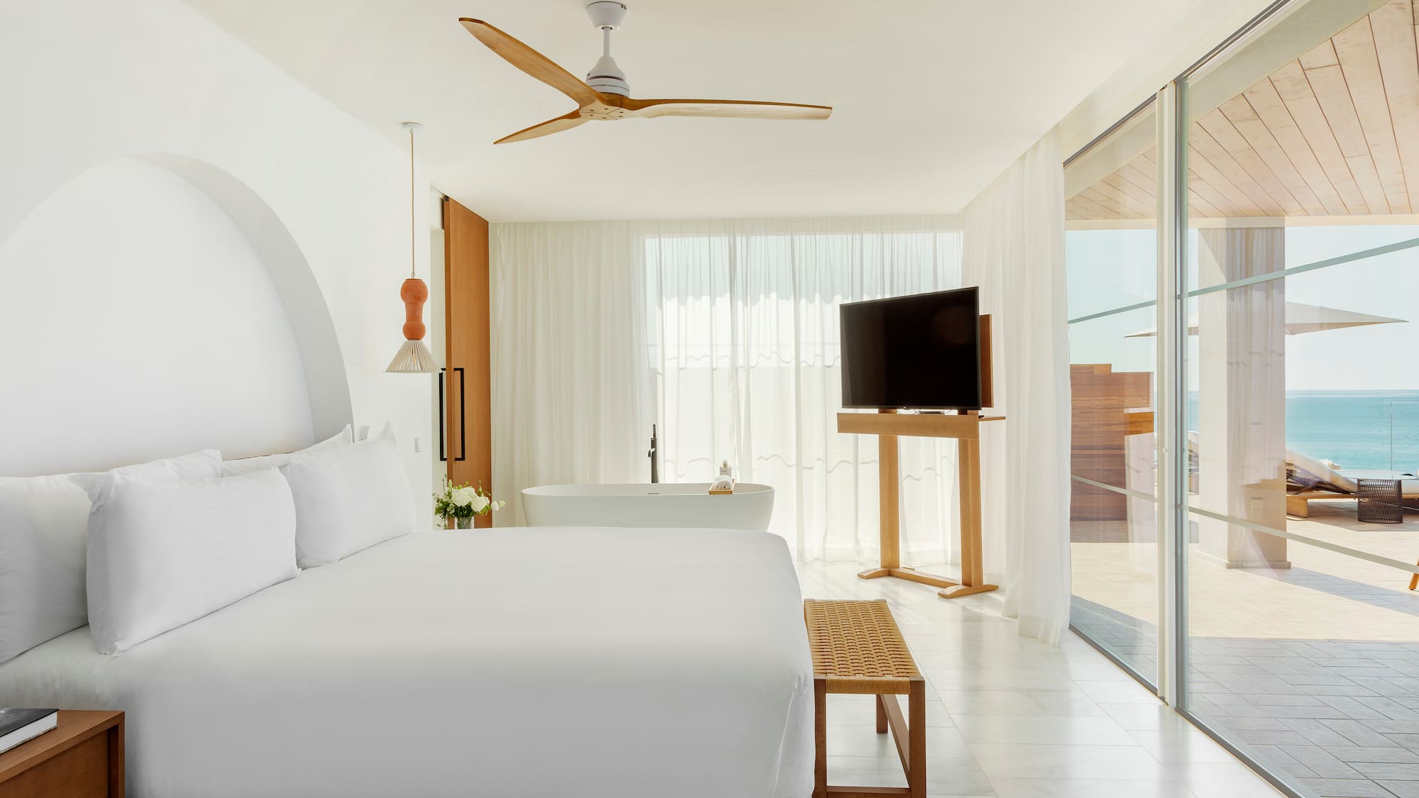 a bedroom with a large bed and a television