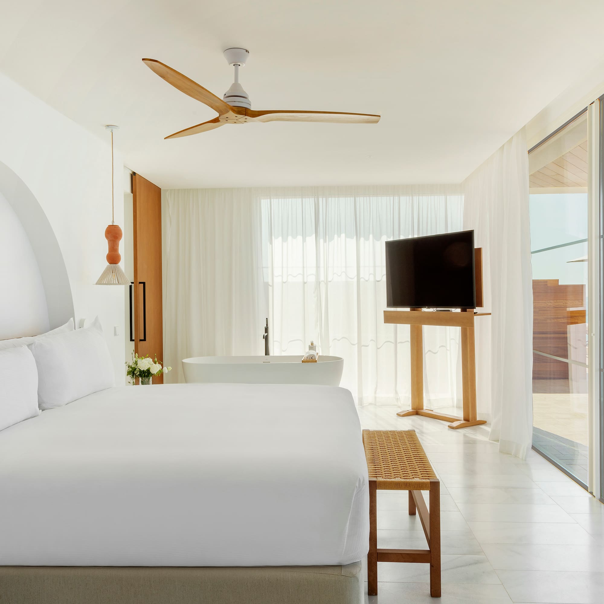 a bedroom with a large bed and a television