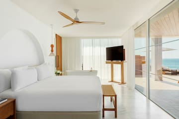 a bedroom with a large bed and a television
