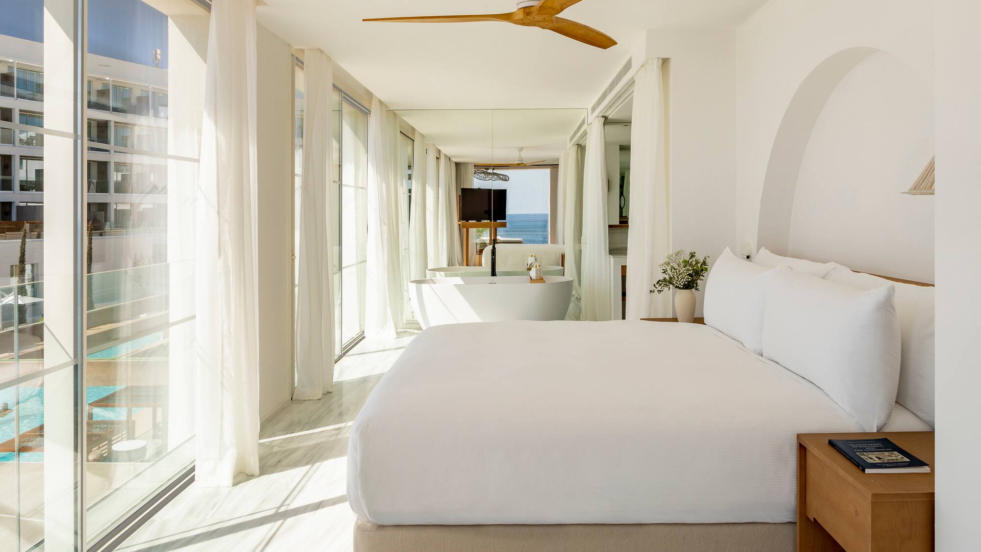 a bedroom with a large bed and a bathtub