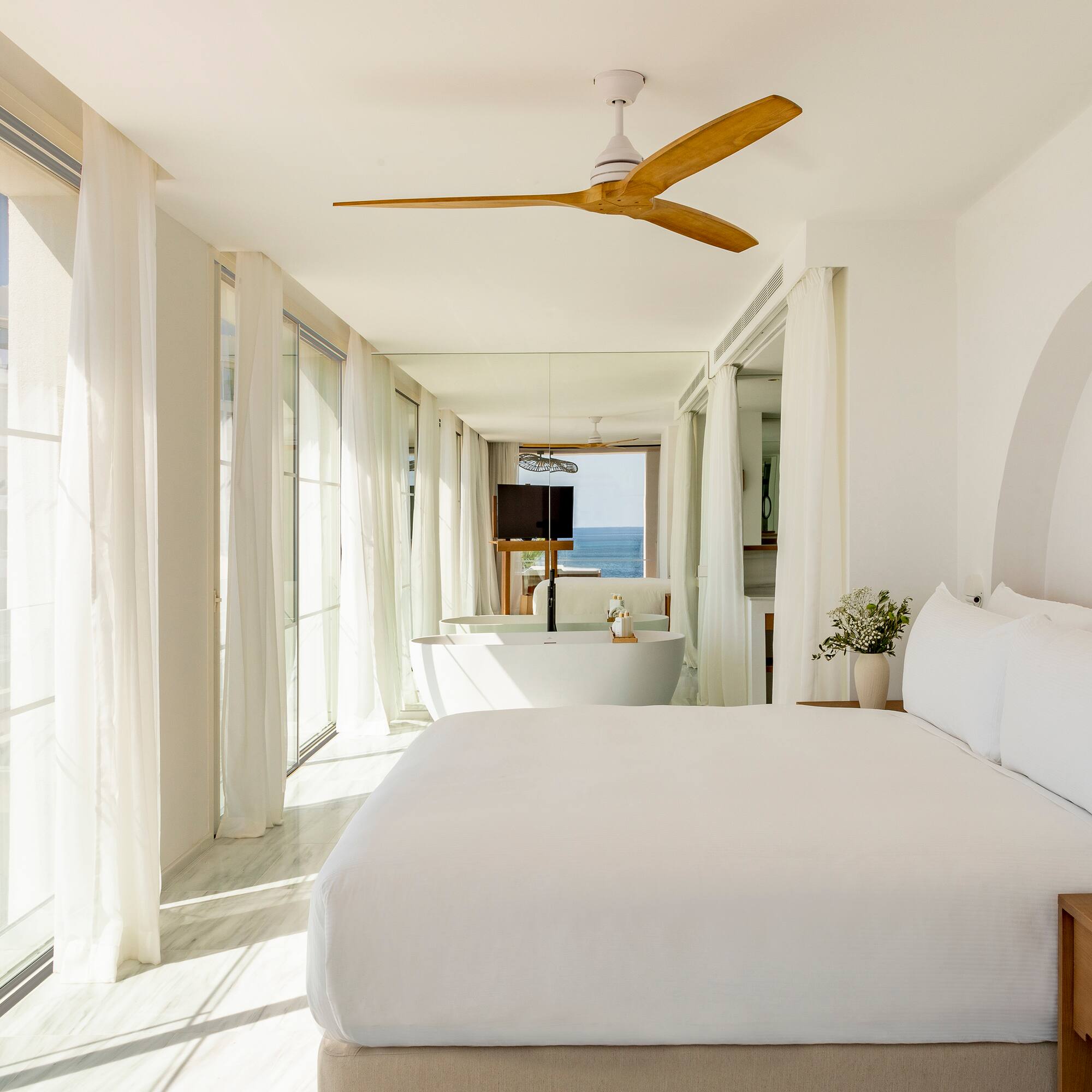 a bedroom with a large bed and a bathtub