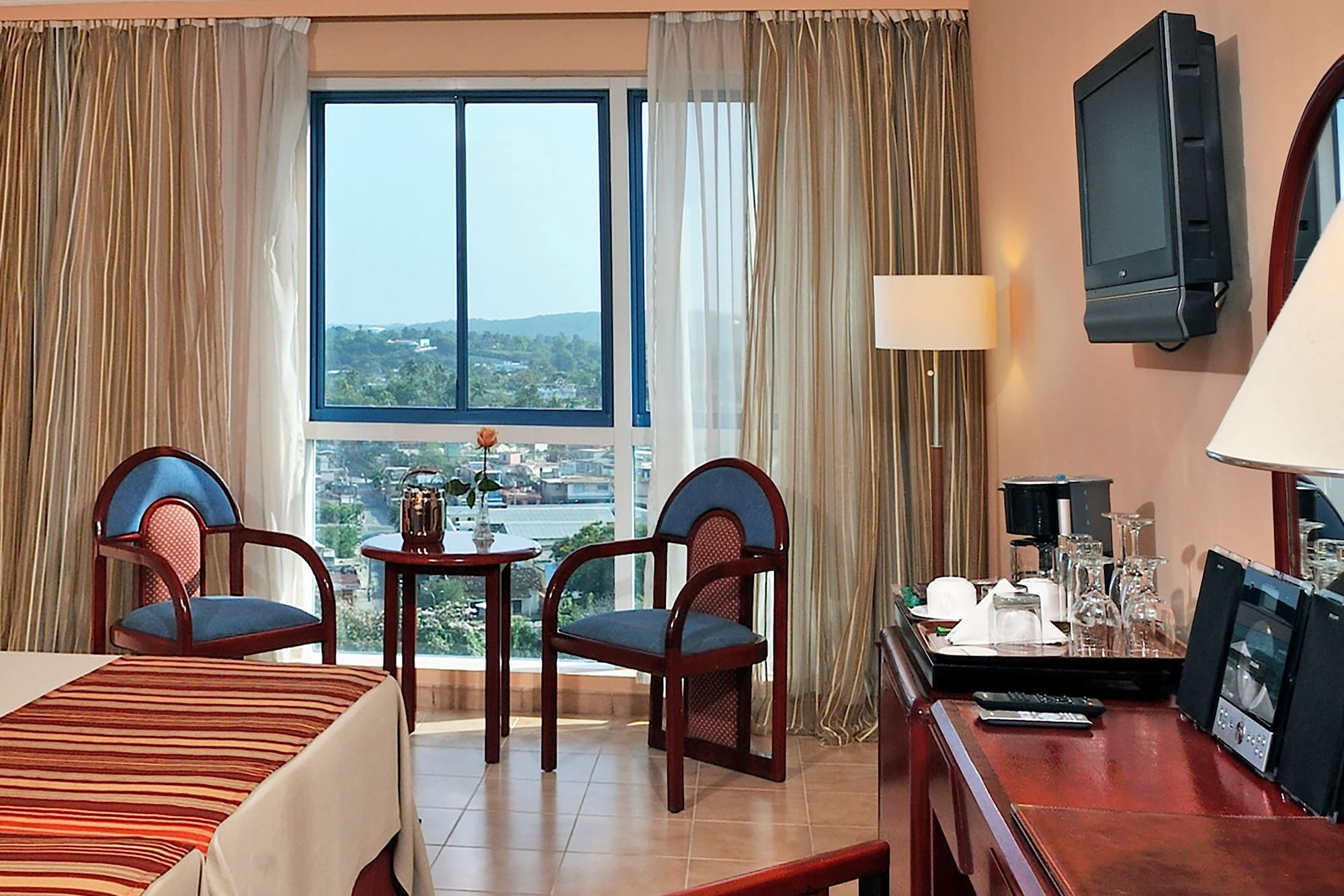 a room with a desk and chairs