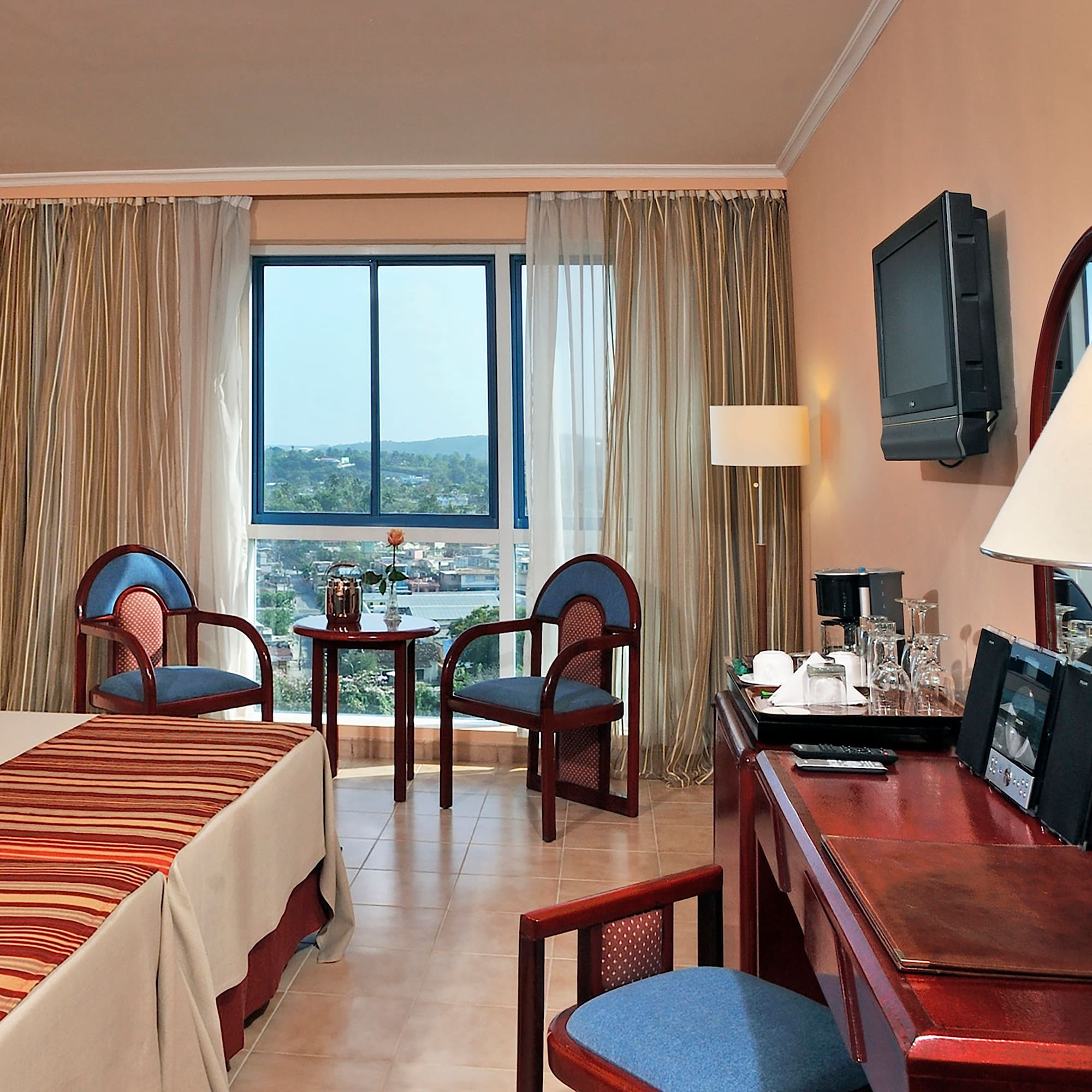 a room with a desk and chairs